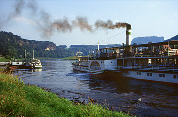 100 years old paddle wheel steamer cruising on the river Elbe near spa town Rathen